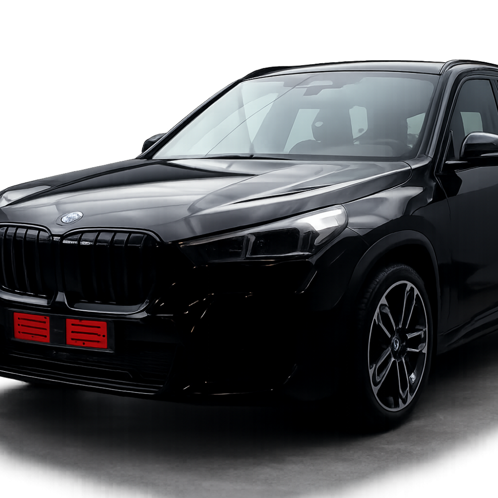 Black glossy SUV shown from a front-left angle in a studio setting, emphasizing its grille and headlights with a red license plate area.