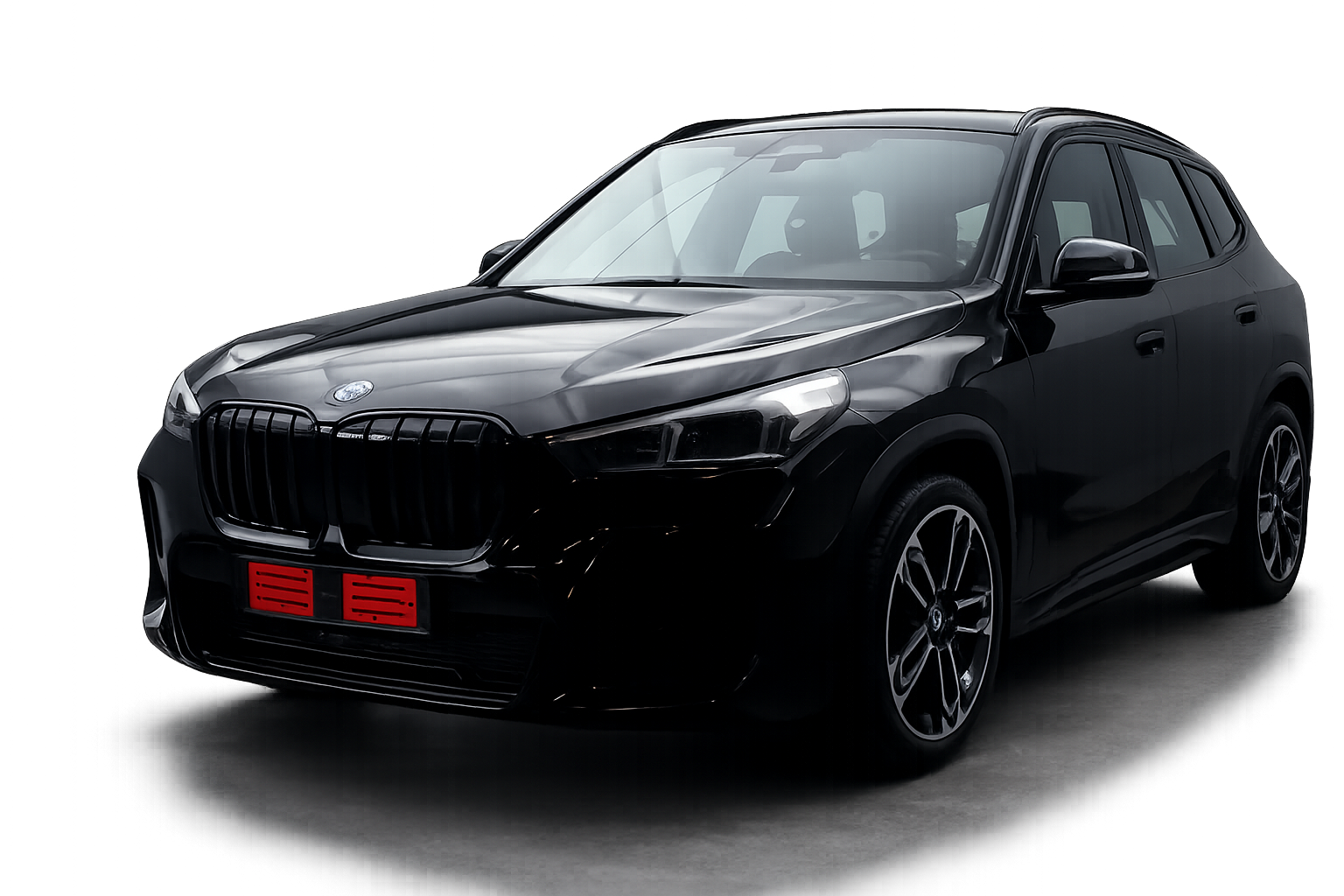 Black glossy SUV shown from a front-left angle in a studio setting, emphasizing its grille and headlights with a red license plate area.