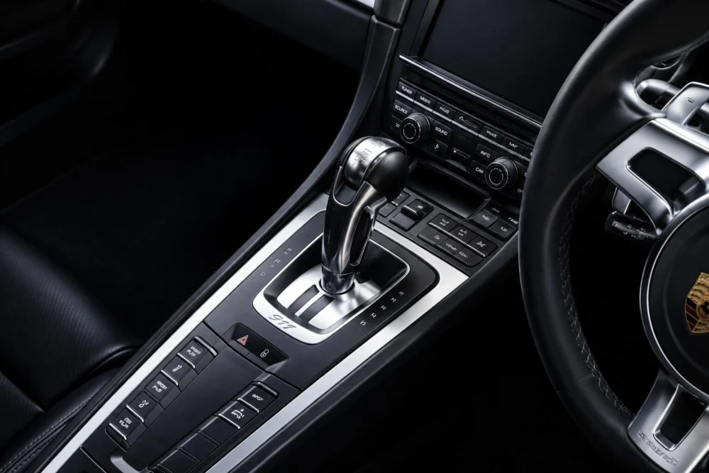 Close-up of a modern car center console with an automatic gear lever and control buttons
