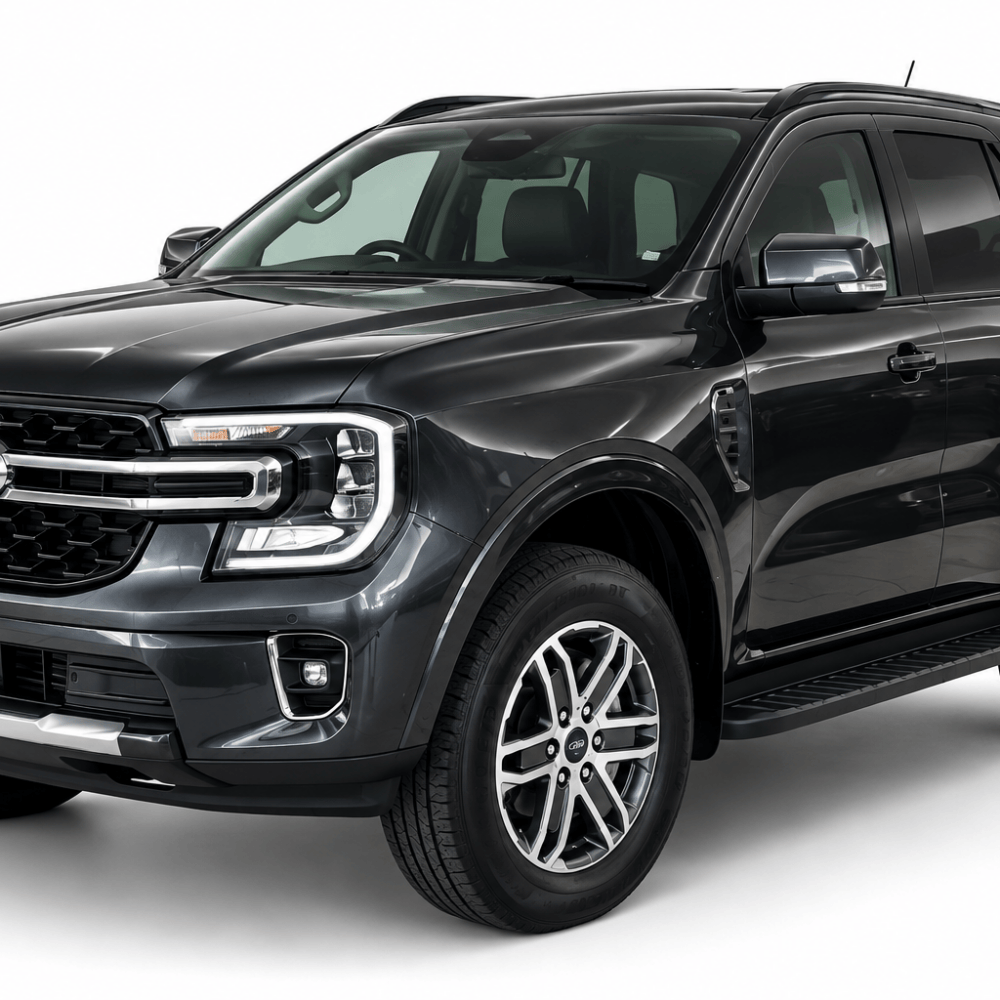 Front three-quarter view of a dark gray Ford SUV pickup with a chrome grille and large alloy wheels, shown against a white background.